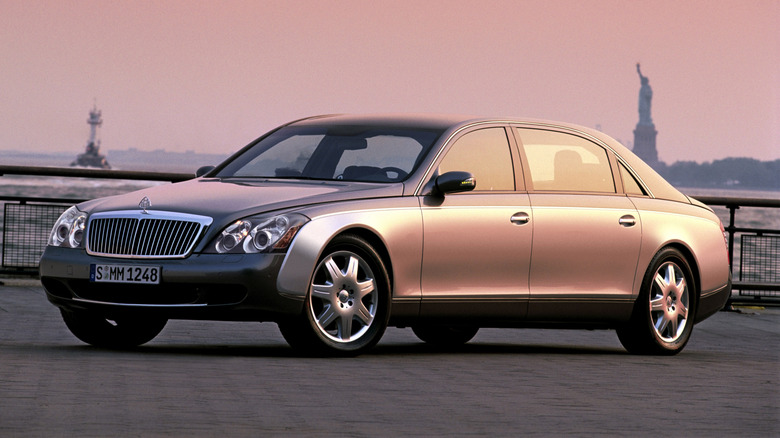 A Maybach 62 parked in dusk in front of the Statue of Liberty.