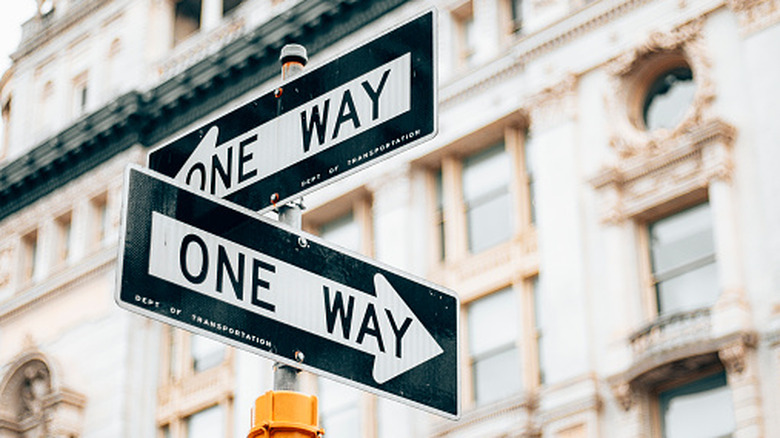 Street signs indicating one-way flow of traffic