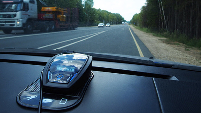 A radar detector on a car's dashboard.