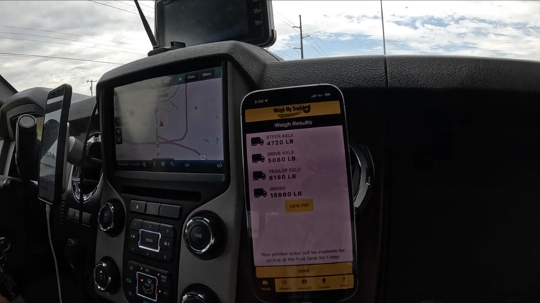 Weigh My Truck app open on a phone in a car