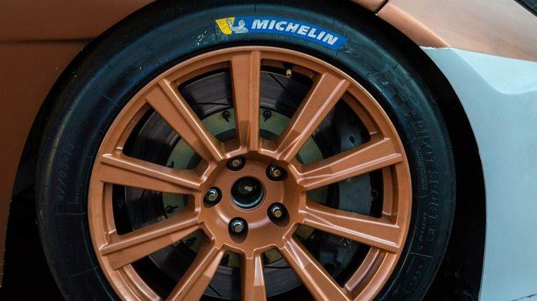 A Michelin tire mounted on a bronze rim.