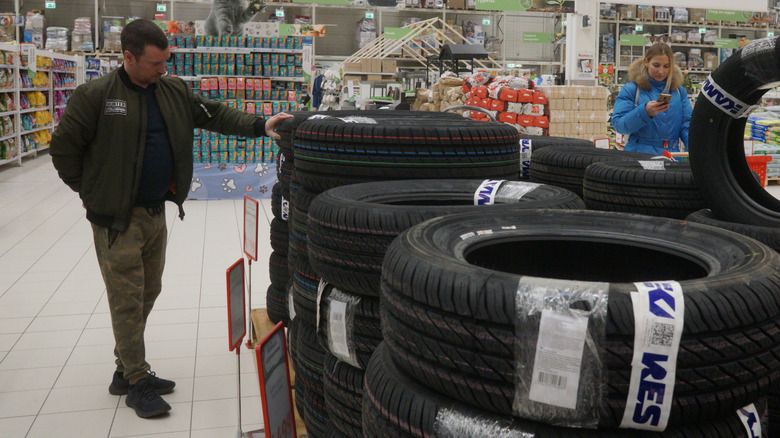A man checks out tires at a discount store.
