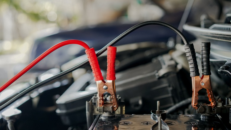 Jumper cables on a dead car battery