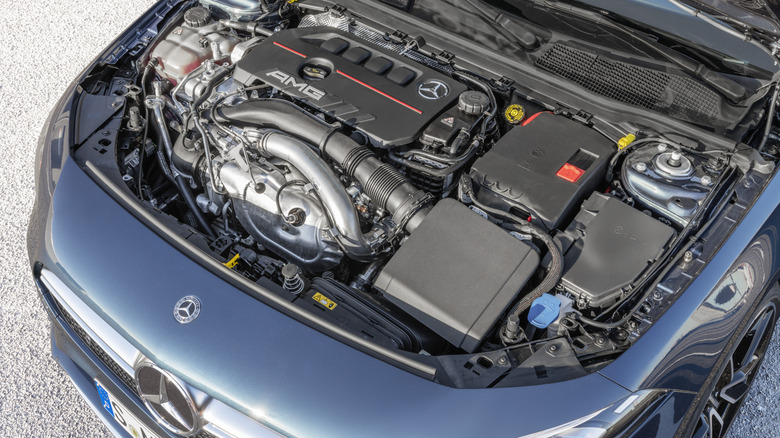 Under the hood of a blue Mercedes-AMG A35, which uses an air-to-water intercooler in its turbocharging system.