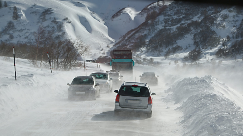 Traffic driving on a snowy highway.