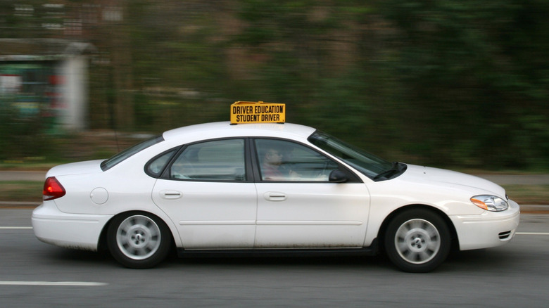A white Ford Taurus with a 