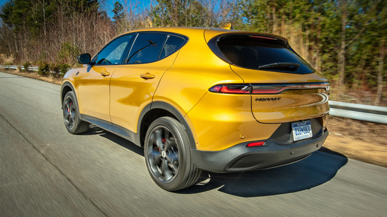 2024 Dodge Hornet rear 3/4 view driving through a forest