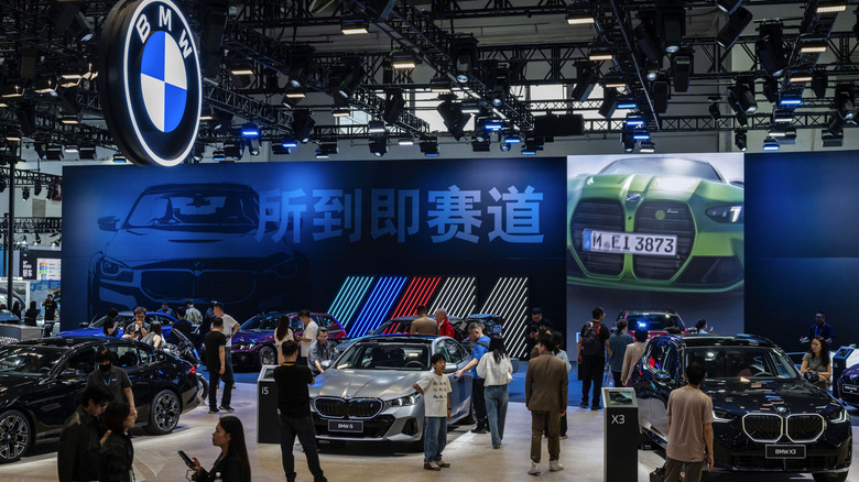 BEIJING, CHINA - APRIL 25:Attendees look at various models of BMW cars on display on the second media day at the Beijing International Auto Exhibition on April 25, 2026 in Beijing, China.The biennial showcase, held at the China International Exhibition Center, brings together leading global and domestic automakers to unveil their latest models, concept vehicles, and electric mobility innovations for the world's largest automotive market. (Photo by Kevin Frayer/Getty Images)