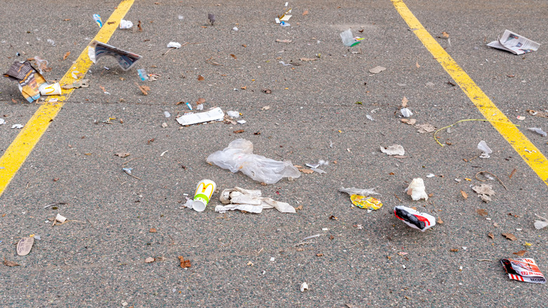 Trash blowing around a parking lot
