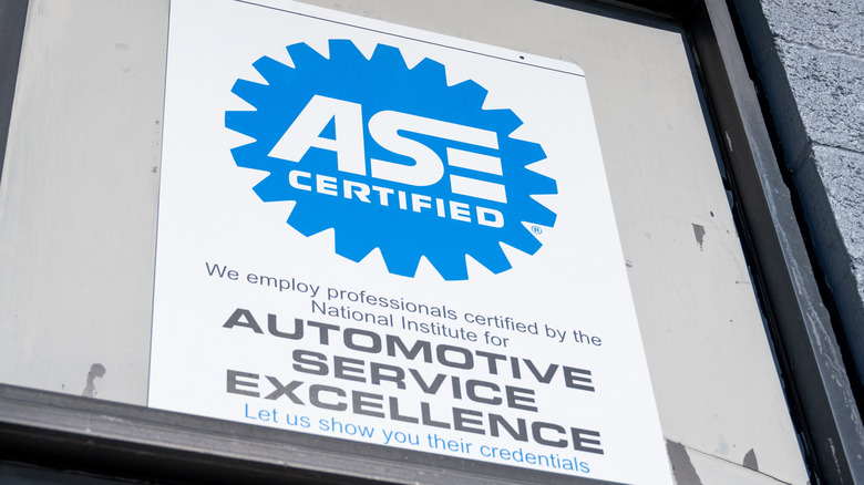 A sign for a mechanic shop advertising the employment of ASE certified mechanics