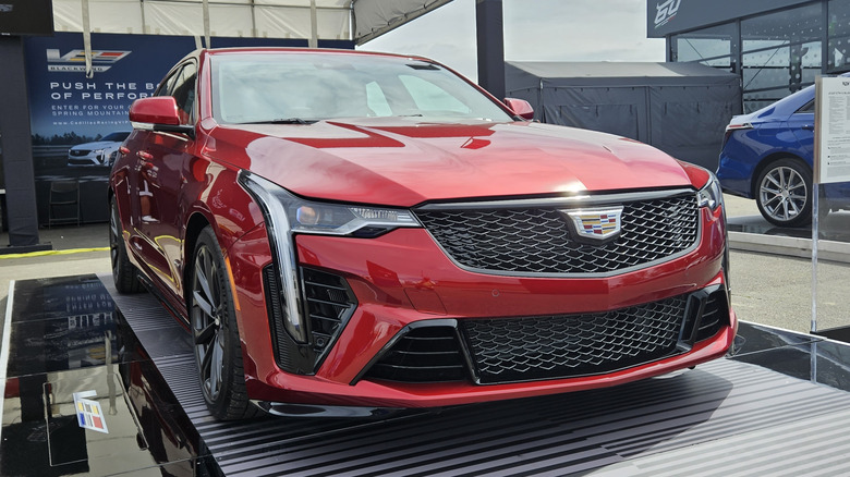 A red Cadillac CT4-V Blackwing sits in a dealership