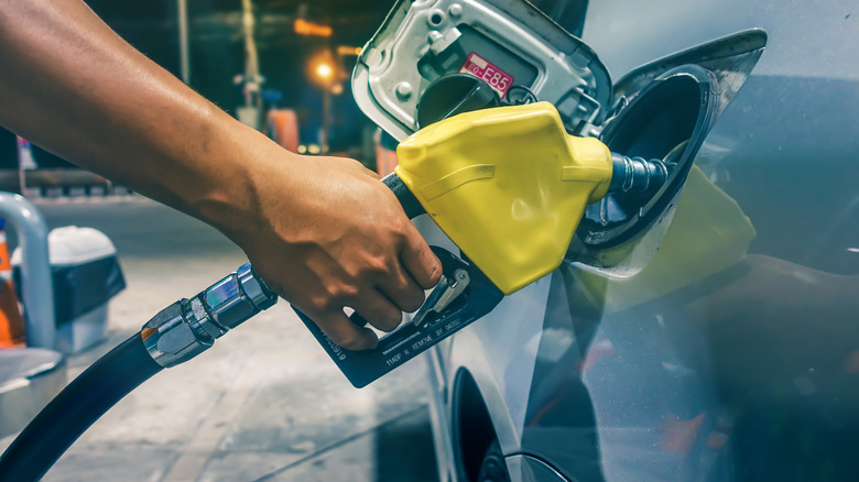 A motorist filling up a vehicle with fuel