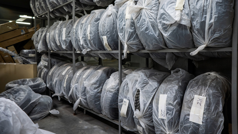 New tires on a storage rack inside a tire store.