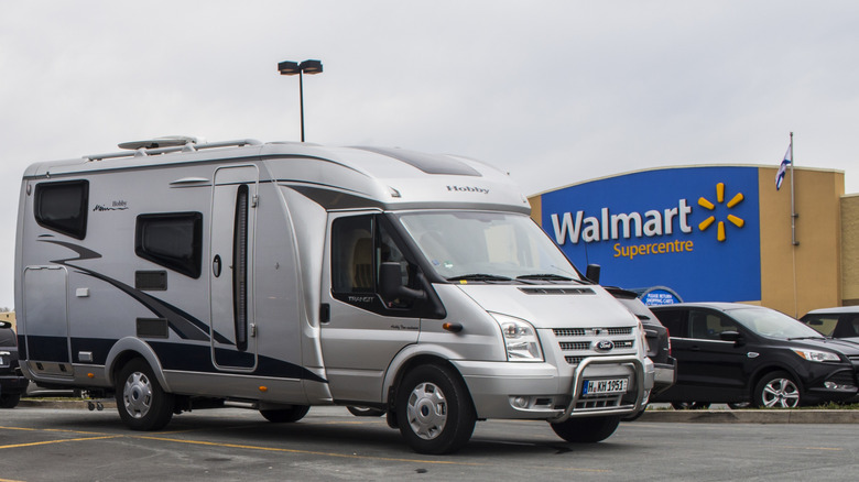 An RV parked in a Walmart parking lot