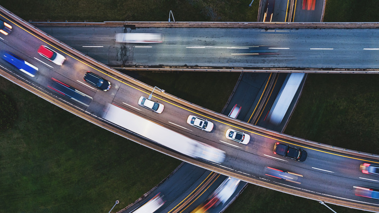 Photo of ariel view of rush hour traffic on three highway overpasses.