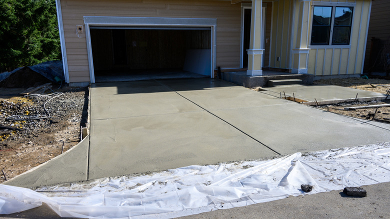 An image of a freshly poured concrete driveway basking in the sun