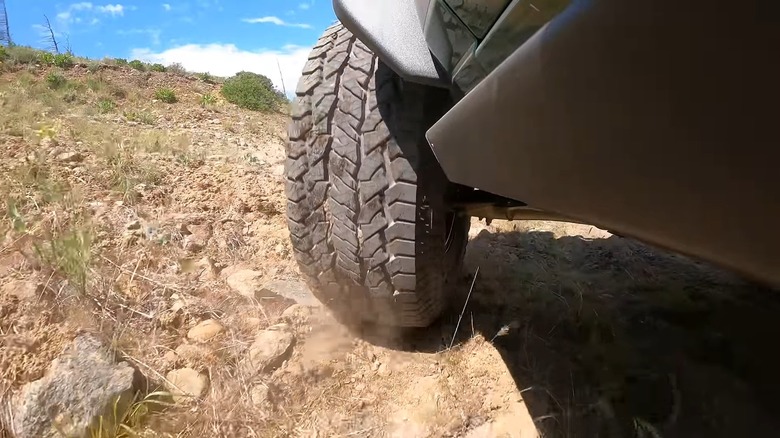 An vehicle driving off-road with all-terrain tires