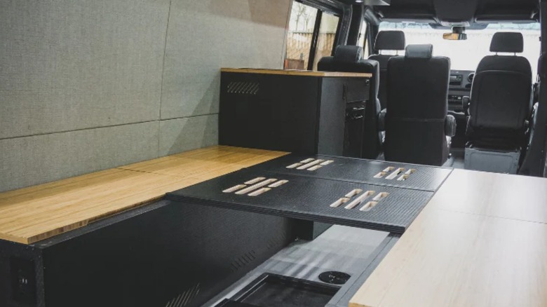 a rear view into the back of a van with a serg supply dinette bed conversion kit
