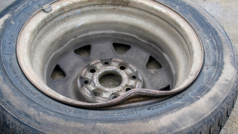 A steel rim with a significant dent on the inner side
