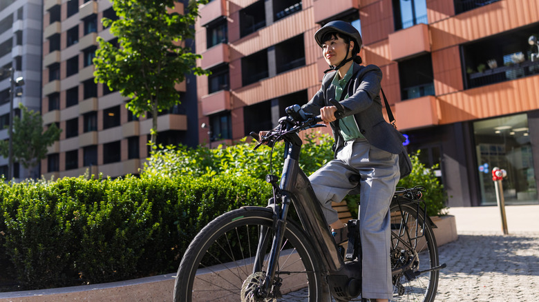 A woman riding an e-bike in the city