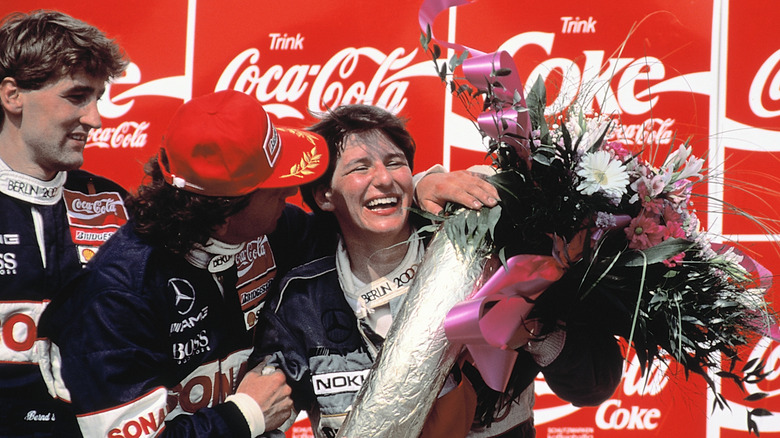 Ellen Lohr celebrating her win on the podium at Hockenheimring in the 1992 DTM race.