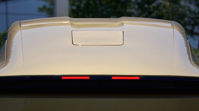 Rear view of a Tesla Robotaxi with an integrated Starlink V5 dish