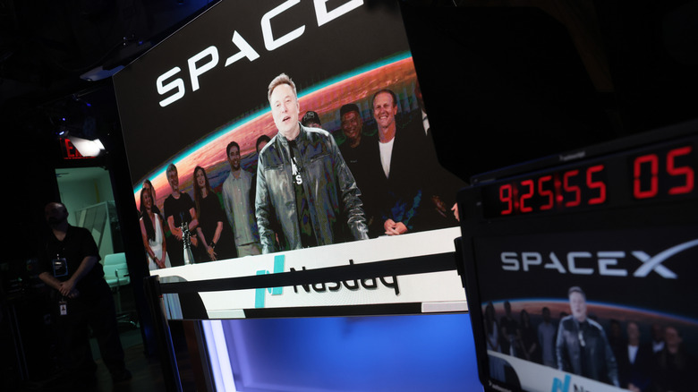 NEW YORK, NEW YORK - JUNE 12: Elon Musk, founder and CEO of SpaceX, speaks via video before the ringing of opening bell at the Nasdaq Marketsite at the launch of the company's initial public offering (IPO) on June 12, 2026 in New York City. SpaceX is set to begin trading under the ticker SPCX following what is expected to be the largest initial public offering in history. Elon Musk, who also serves as chief executive of Tesla, could become the world's first trillionaire. In a filing with the Securities and Exchange Commission, the company said it plans to raise $75 billion by selling 555.6 million shares at $135 each. (Photo by Spencer Platt/Getty Images)
