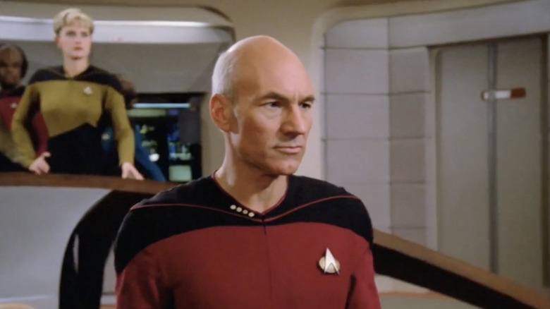 a screen grab from Star Trek of Captain Jean Luc Picard standing on the bridge of the USS Enterprise