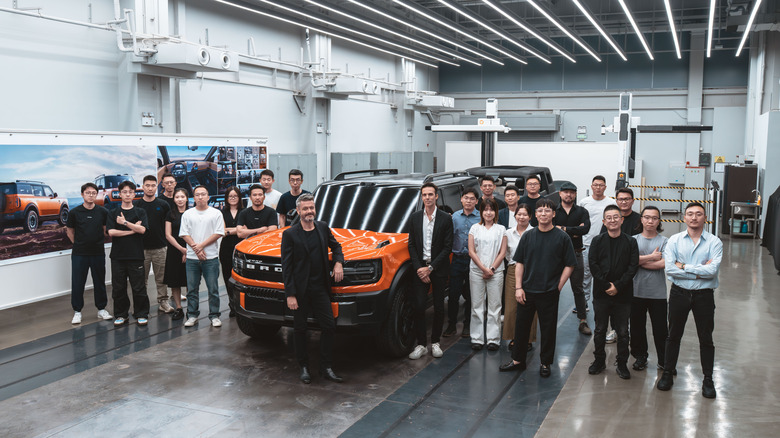 An electrified Ford Bronco prototype surrounded by workers successful China