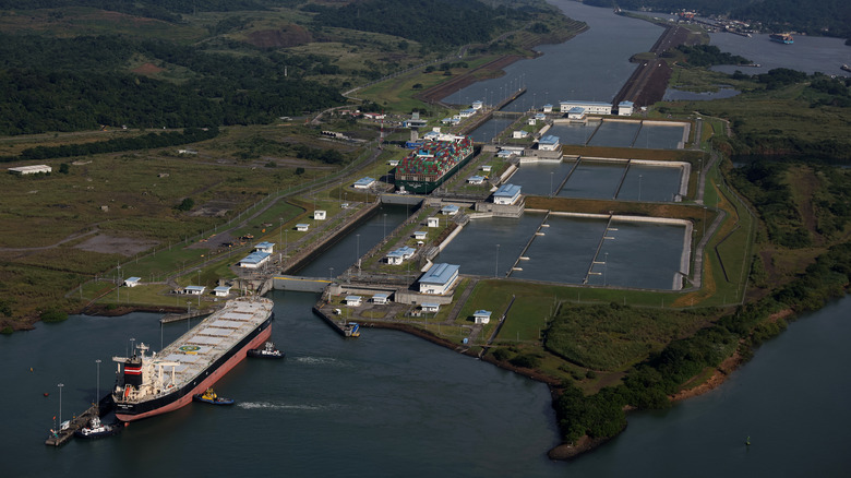 In an aerial view, the container ship Tampa Triumph passes through the Miraflores Locks as it transits the Panama Canal on September 20, 2023 in Panama City, Panama.