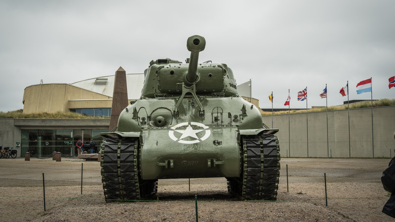 A head-on view of an M4A4 Sherman tank at a military base.