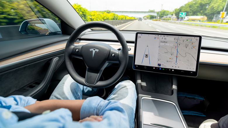 Driver using Tesla driver aids with hands off the wheel