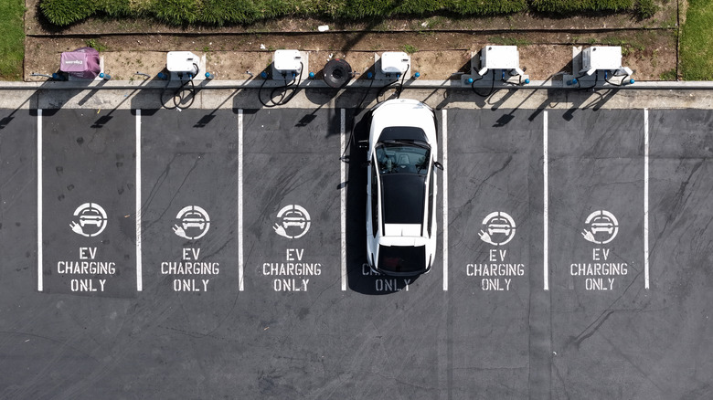 In an aerial view, an electric vehicle charges at an EVgo electric charger on March 30, 2026, in Monrovia, California.