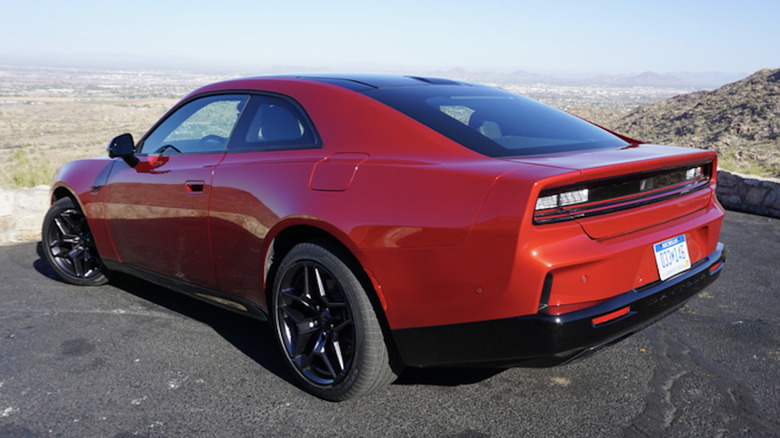 Rear 3/4 position of a reddish Dodge Charger Daytona
