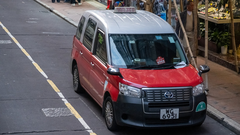 Hong Kong, China, 03 08 2025 : Typical red taxi in Hong Kong. Toyota.