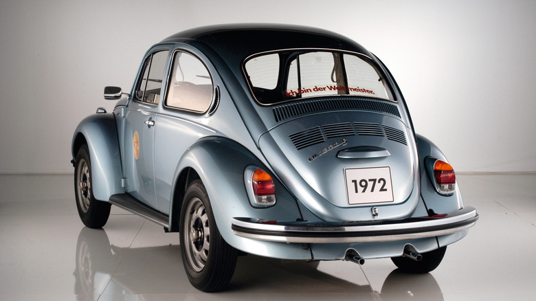 Rear-quarter shot of a 1972 Volkswagen Beetle in a studio setting.