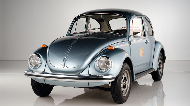 Front-quarter shot of a 1972 Volkswagen Beetle in a studio setting.