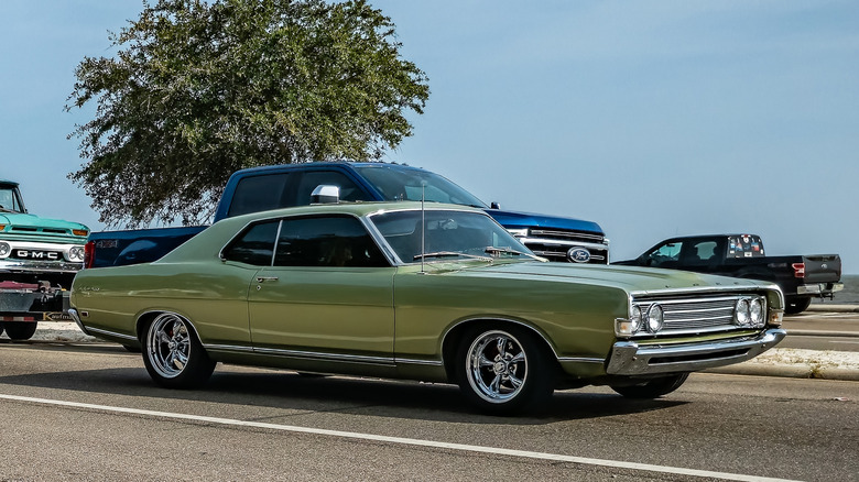 A green 1969 Ford Fairlane 500 Two-Door Hardtop driving alongside traffic