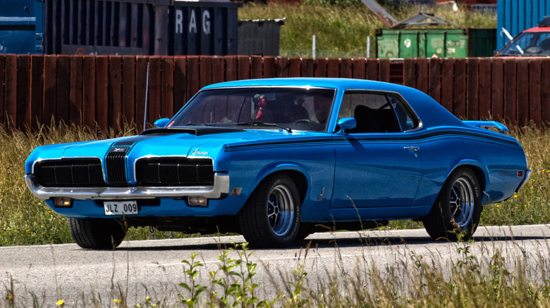 A 1969 Mercury Cougar GT-E parked by tall grass