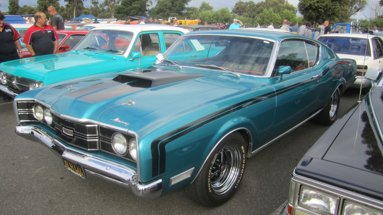 A teal 1969 Mercury Cyclone GT parked next to other classic cars