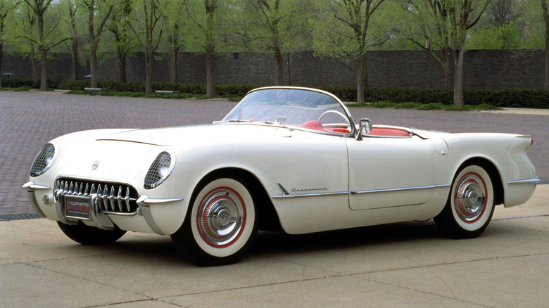 One of 300 original white on red 1953 Corvettes, pictured in a stone and pavement background.