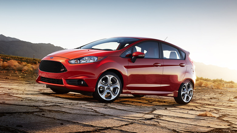A red 2015 Ford Fiesta ST four-door hatchback at twilight