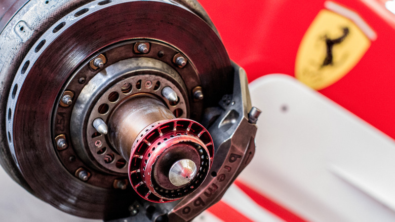 Exposed Brembo caliper and carbon disc brake rotor of a Ferrari F1 car.