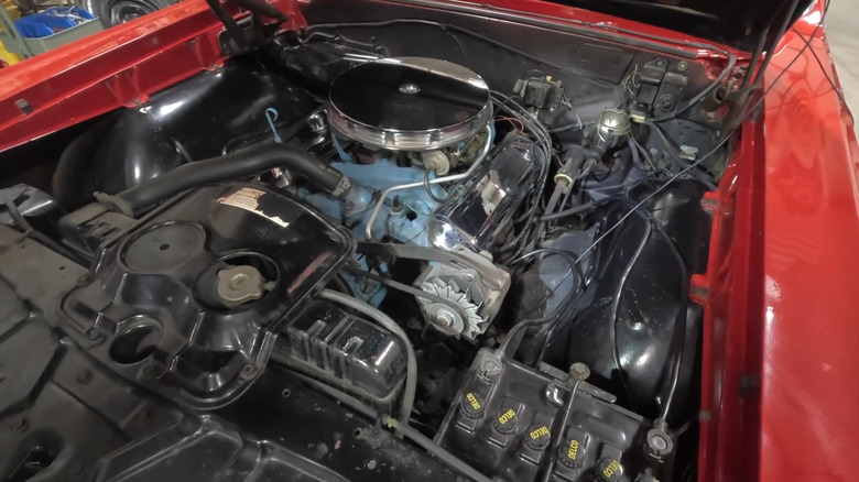 A close-up of the engine bay of a 1965 Pontiac GTO.