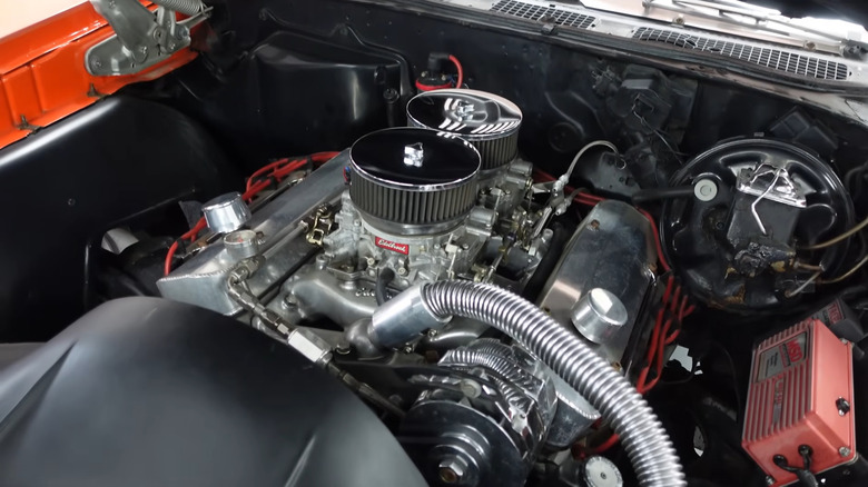 A close-up of an engine bay shows the Pontiac GTO's V8.
