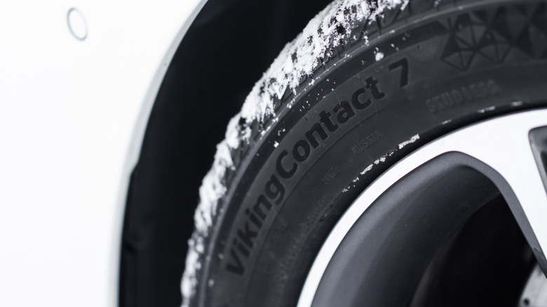 Closeup of a Viking Contact 7 Tire on a white car.