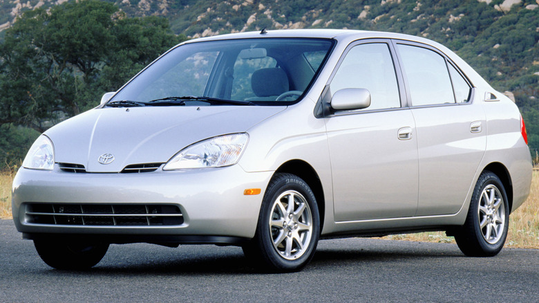 2001-2003 Toyota Prius parked on a paved surface with a large mountain in the background
