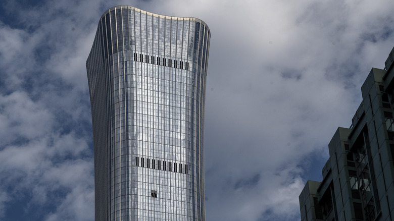 Visible damage on the Citic Tower after a light aircraft crashed into it