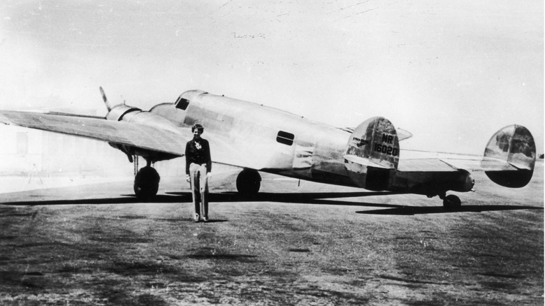 Amelia Earhart standing next to her Lockheed Electra 10-E
