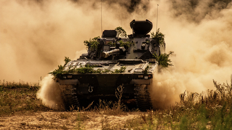 CV90 storming through a dirt trail